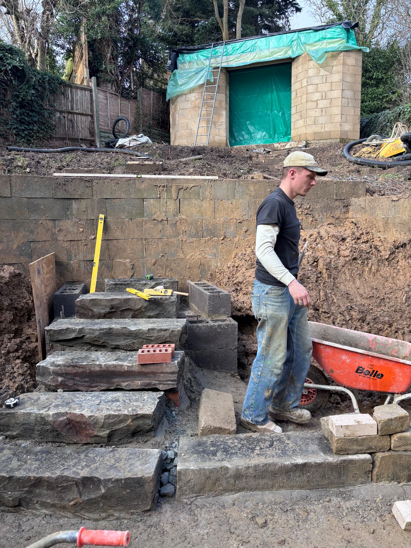 Setting reclaimed stone steps into a blockwork retaining structure