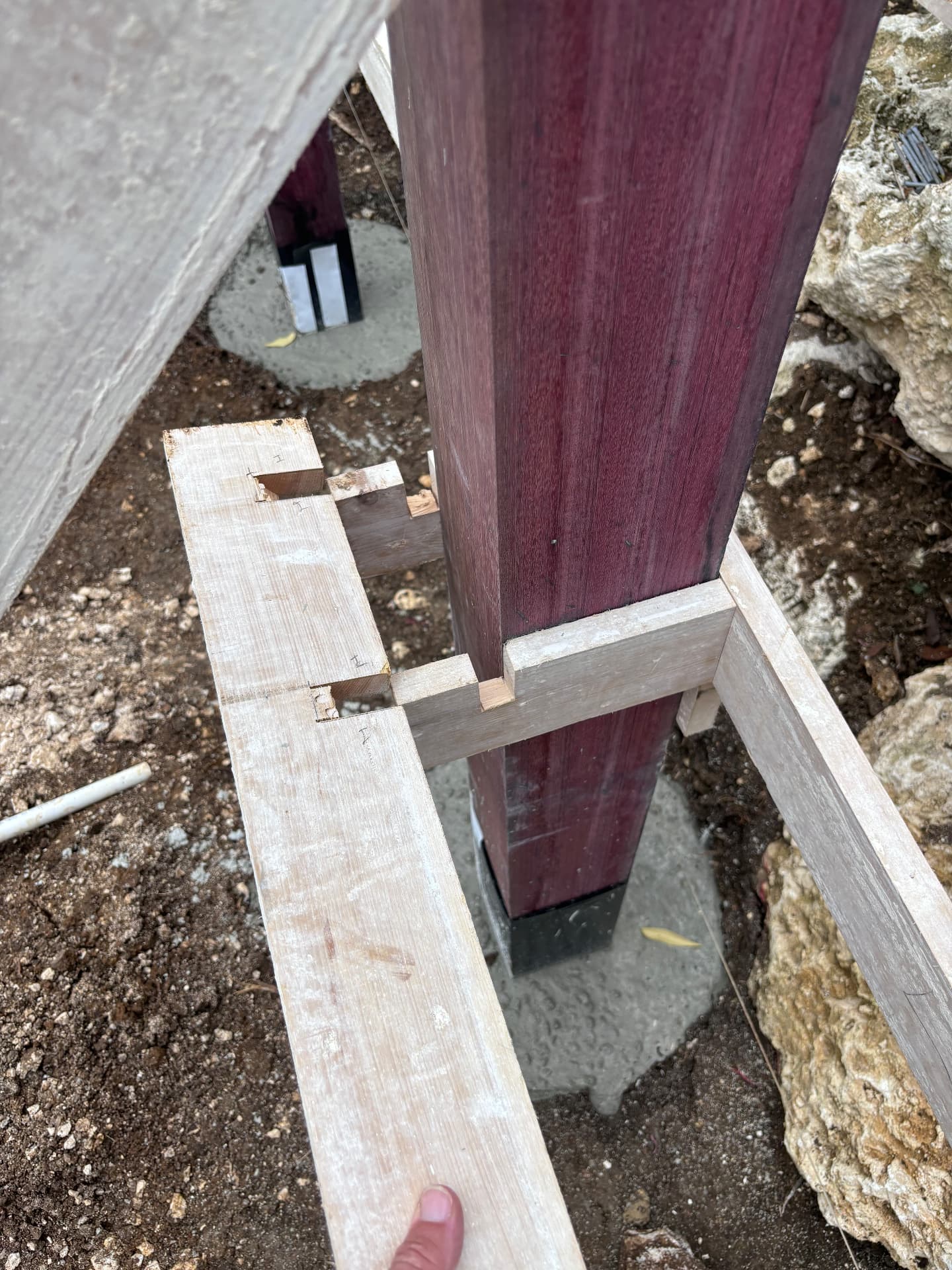 Detail of timber bracing holding a purpleheart post plumb in its footing